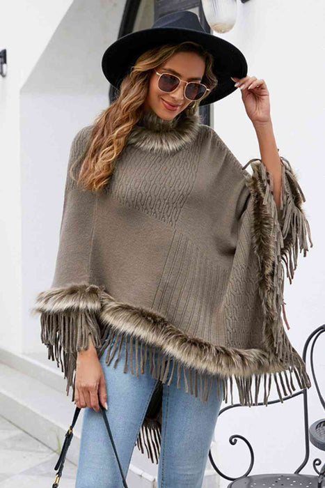 Stylish poncho features faux fur trim