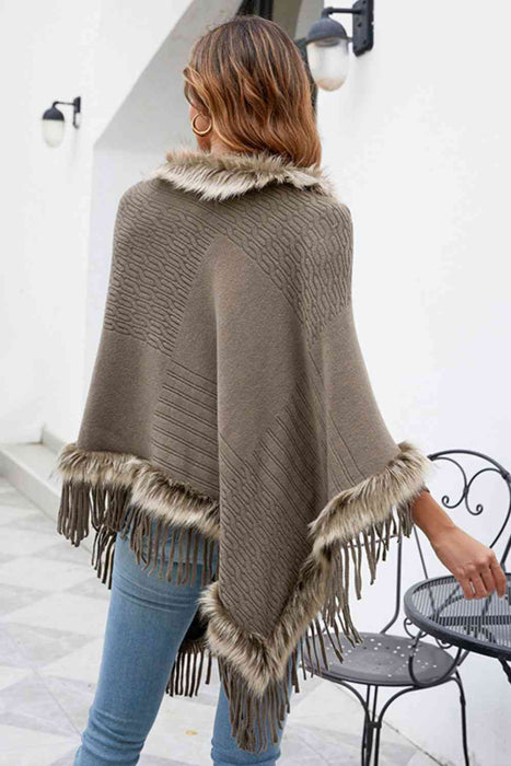 Stylish poncho features faux fur trim